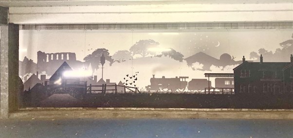 Mural: an image of a steam train, paying homage to the abandoned railway line.
