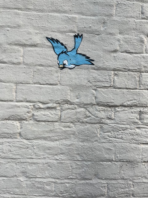 The image of a swooping blue bird. Part of street art in Winchester.